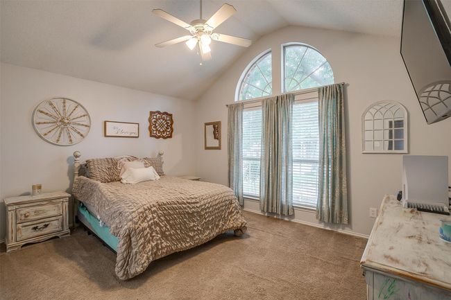 Carpeted bedroom featuring high vaulted ceiling and ceiling fan | Image 25