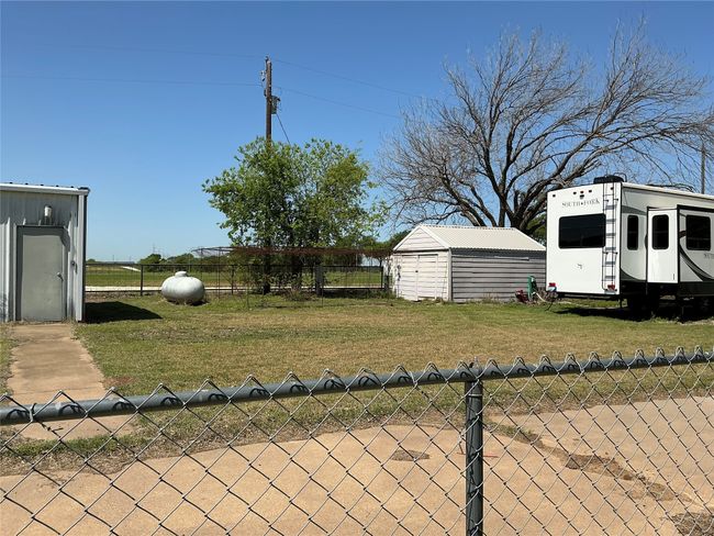 View of yard featuring fence, an outbuilding, and a shed | Image 26