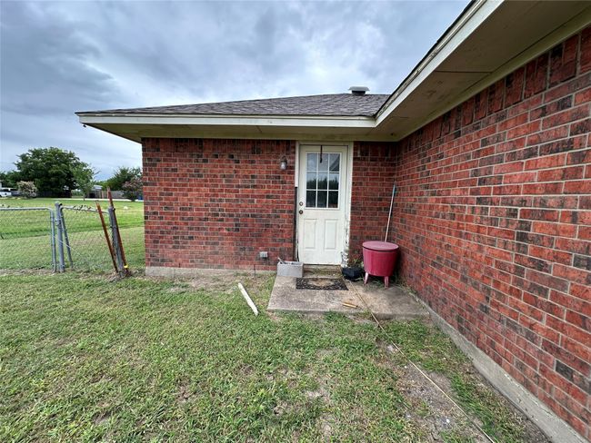 Property entrance with brick siding and roof with shingles | Image 23