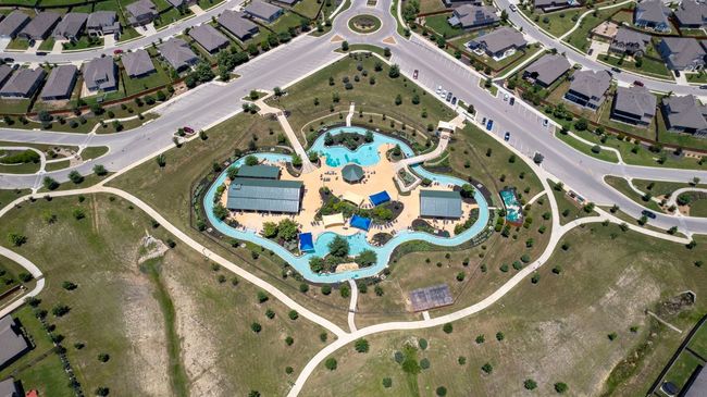 View of property location with a pool and nearby suburban area | Image 34