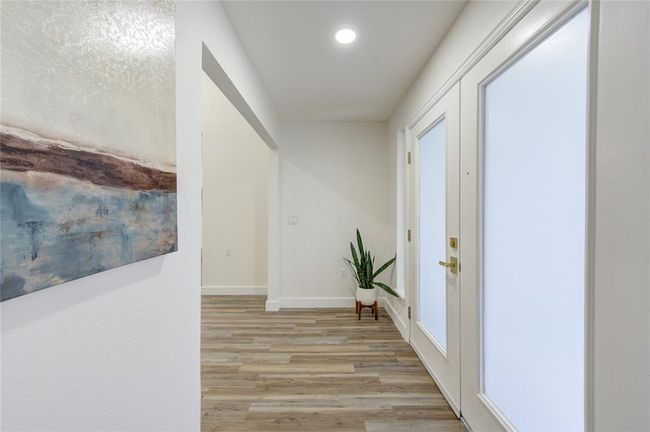 As you step through the front door, you're immediately greeted by a bright and airy entryway, bathed in natural light from the large new windows. | Image 5