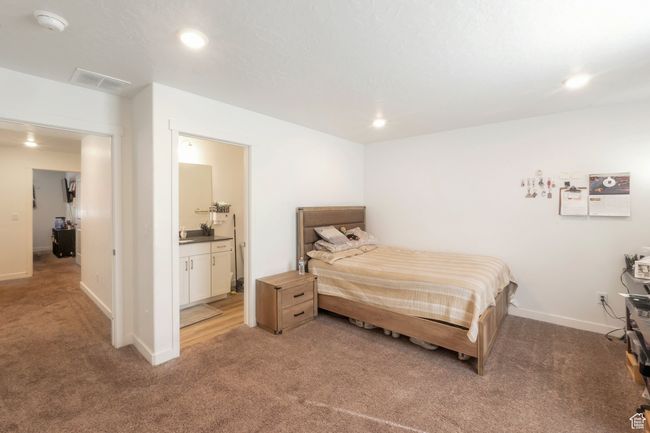 Bedroom featuring light carpet, recessed lighting, and connected bathroom | Image 9
