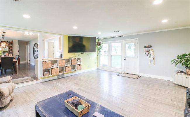 Living area with ornamental molding, wood finished floors, and recessed lighting | Image 17