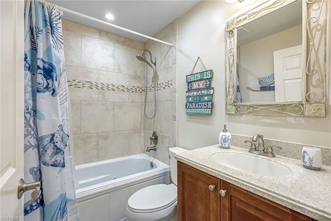 Bathroom featuring vanity and shower / bath combination with curtain | Image 13