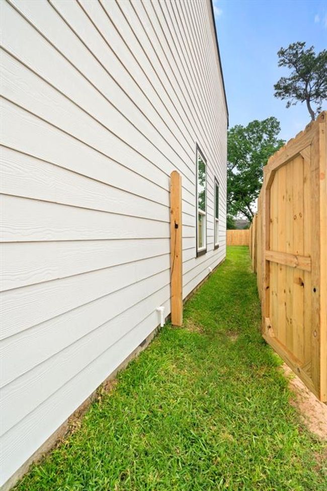 Easy side access to your private backyard! This convenient side entrance offers quick, private access to your fully-fenced backyard. Readyto see it for yourself? Schedule your private showing today and experience all the possibilities this home has to offer! | Image 30