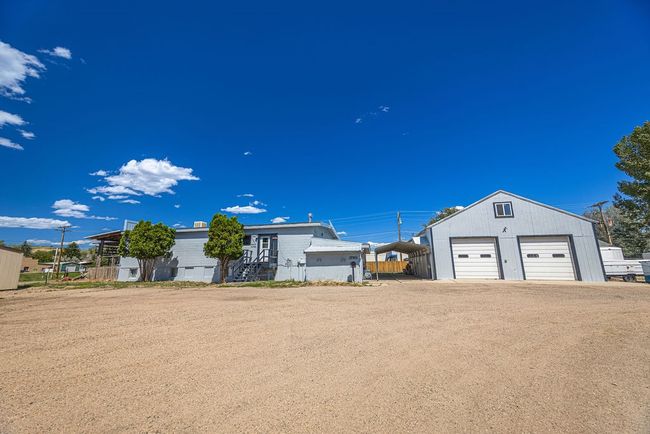 View of front of home with a garage and an outbuilding | Image 23