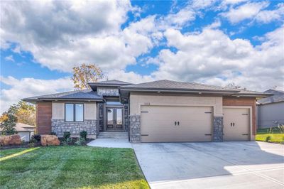 Prairie-style home featuring a garage and a front lawn | Image 1