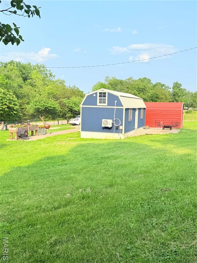 View of grassy yard featuring an outdoor structure | Image 37