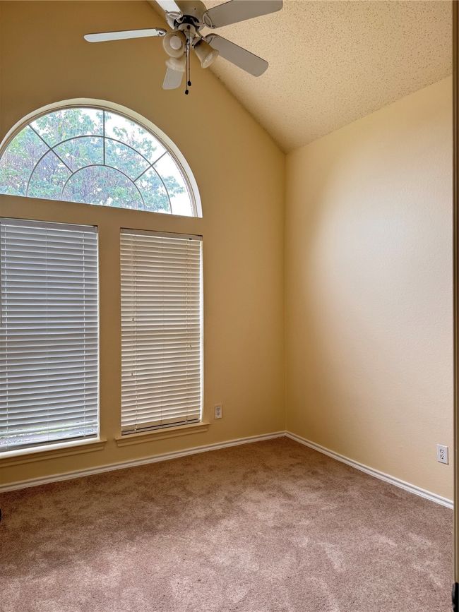 Spare room featuring carpet flooring, ceiling fan, and lofted ceiling | Image 8