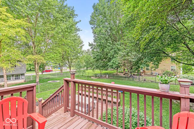 wooden terrace with a fenced backyard | Image 26