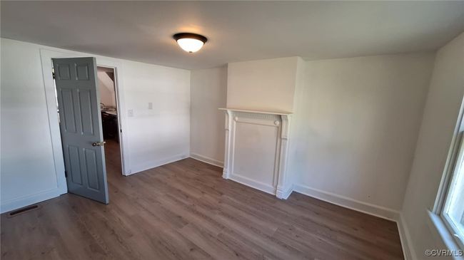 Unfurnished room featuring visible vents, baseboards, and wood finished floors | Image 20