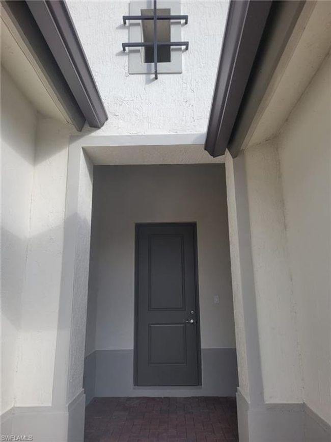 Doorway to property with stucco siding | Image 27