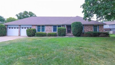 Single story home with a garage and a front yard | Image 1