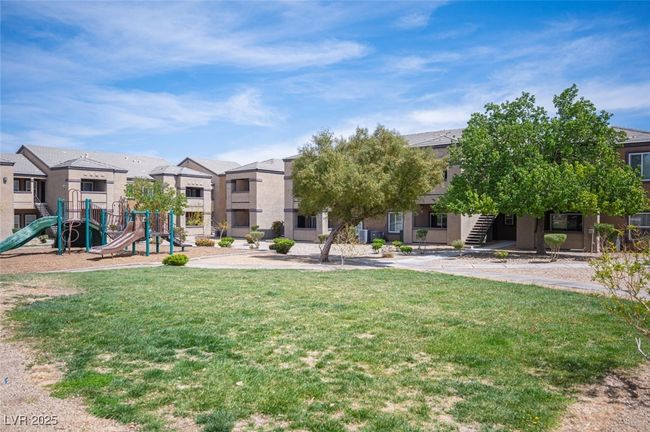 View of community with playground community, a residential view, and a lawn | Image 33