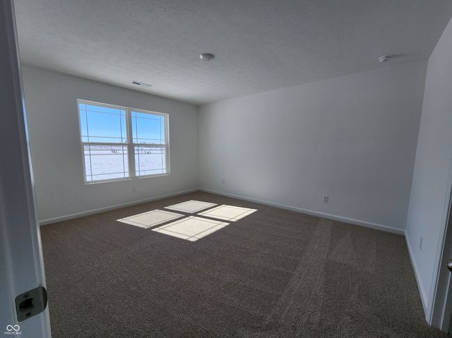 carpeted empty room featuring recessed lighting, visible vents, and baseboards | Image 12