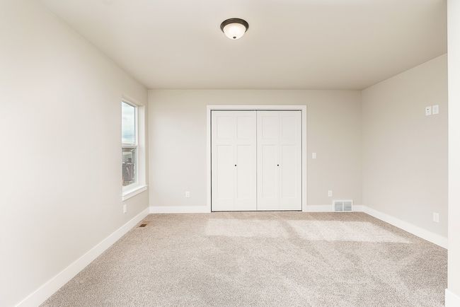 Unfurnished bedroom featuring visible vents, carpet floors, baseboards, and a closet | Image 11