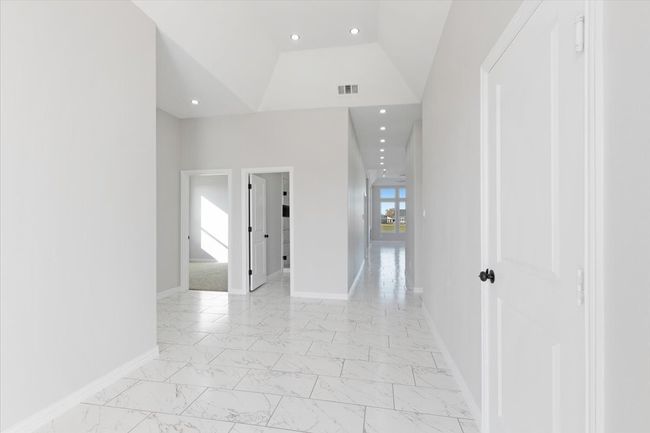 Hallway featuring light marble finish floors and recessed lighting | Image 4