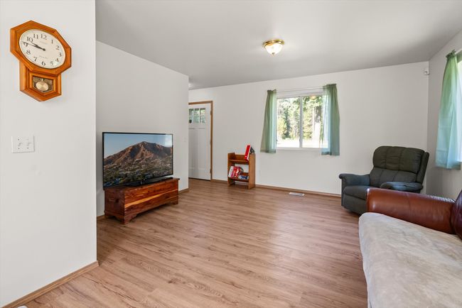 Living room featuring light wood-style flooring and baseboards | Image 9