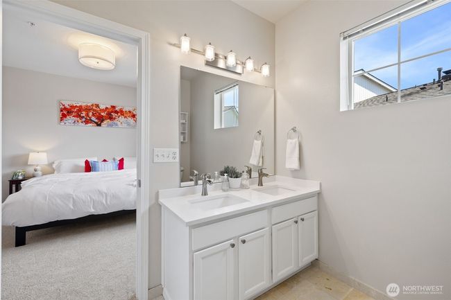 Primary bath with newer dual vanity, quartz counters, new lighting and tile floors | Image 27