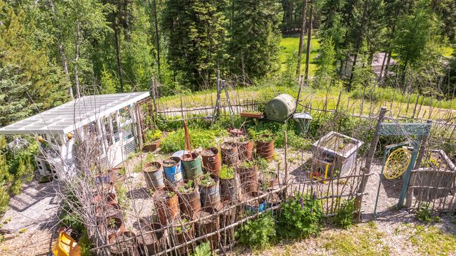 View of yard with a garden, an exterior structure, and an outdoor structure | Image 69
