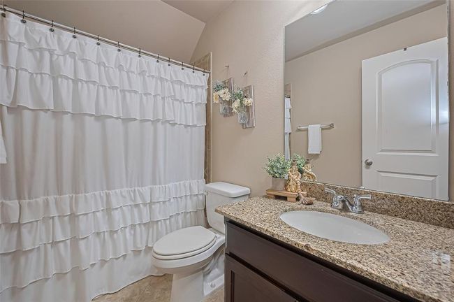 Guest bathroom number three mirrors the second with granite countertops, nickel finishes, and a tub/shower combination, offering consistent style and comfort. | Image 35