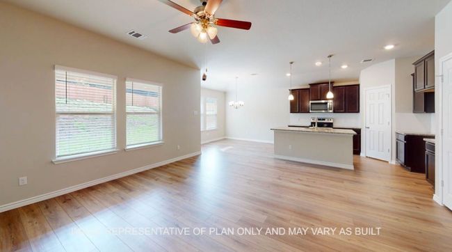 Kitchen featuring appliances with stainless steel finishes, a ceiling fan, open floor plan, baseboards, and light wood-type flooring | Image 9