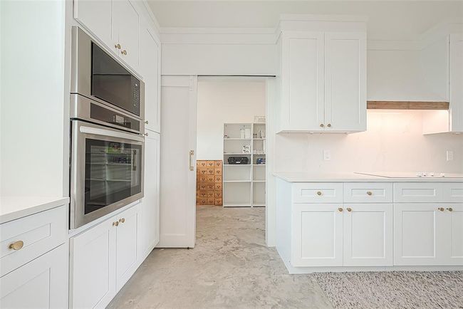 Butler's pantry straight ahead with barn door. | Image 10