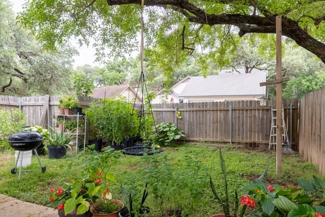 View of fenced backyard | Image 15
