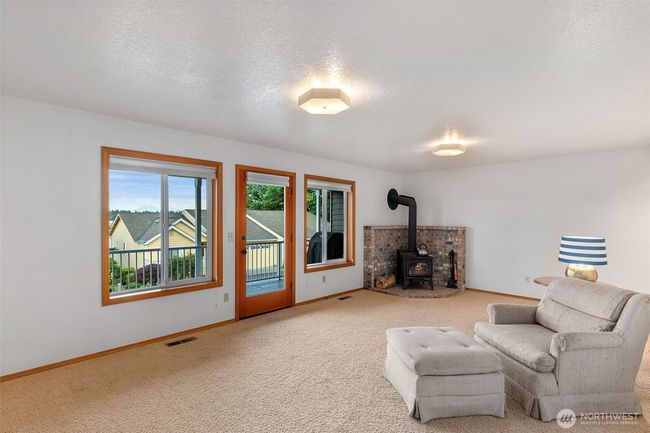 Going down.....Amazing bonus living space with cozy wood burning stove that is maintained by the HOA | Image 26