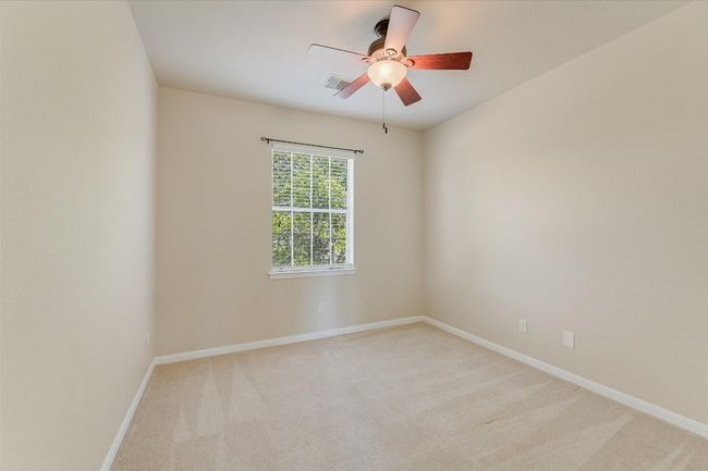 Spare room with light carpet and ceiling fan | Image 14