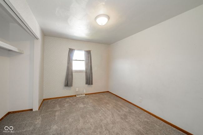 unfurnished bedroom featuring a closet, visible vents, baseboards, and carpet floors | Image 18