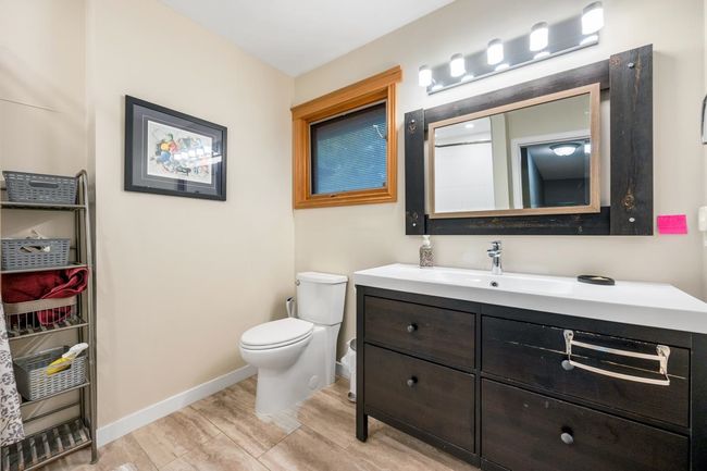 Bathroom featuring vanity, toilet, wood finished floors, and baseboards | Image 19