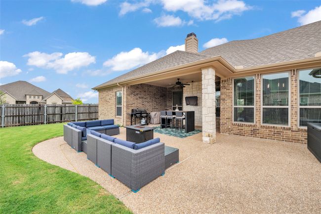View of patio featuring an outdoor hangout area, grilling area, and a ceiling fan | Image 5