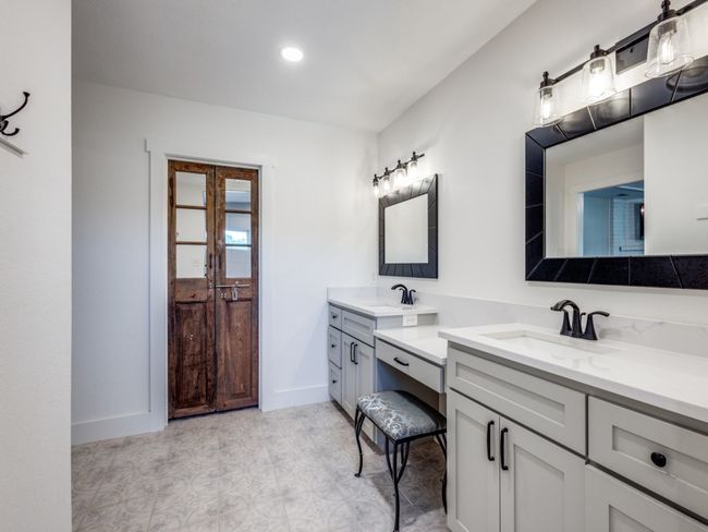Beautifully updated master bathroom with two sinks, seated vanity area, plenty of storage, large walk-in closet and a glamourous separate tub and shower you won't believe! | Image 17