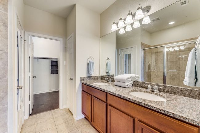As you enter the owners suite bath, notice the dual vanity and stannding shower. | Image 16
