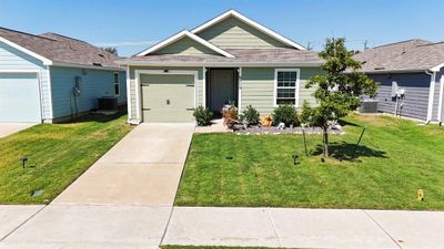 Single story home with a front yard and cooling unit | Image 1