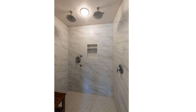 Bathroom featuring a tile shower | Image 18