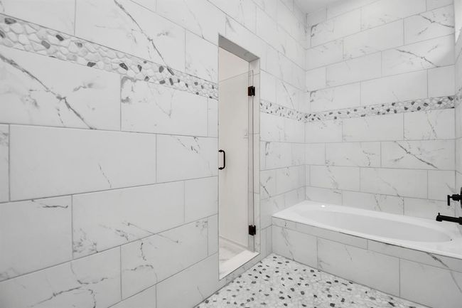 Tub is located within the shower area of the primary bath | Image 34