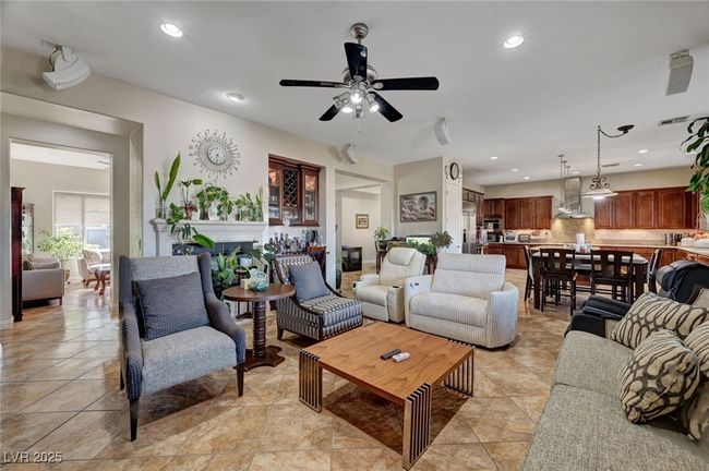Living room with a ceiling fan, recessed lighting, a fireplace, and light tile patterned floors | Image 28