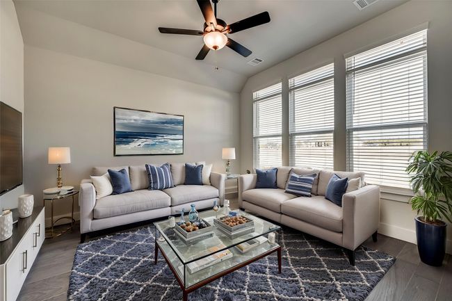 Living room featuring dark wood finished floors, a ceiling fan, vaulted ceiling, visible vents, and baseboards | Image 17