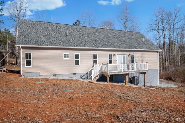 Rear view of house includes a deck for entertaining outside | Image 26