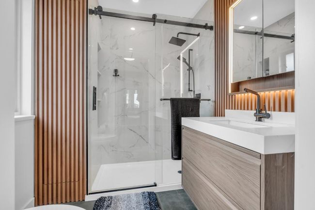 Full bathroom featuring vanity and a marble finish shower | Image 22