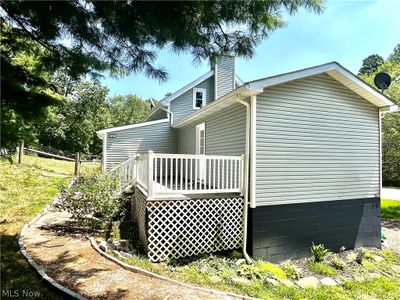 View of property exterior with a wooden deck | Image 3