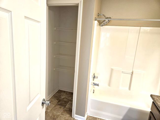 full bathroom featuring shower / washtub combination, vanity, and baseboards | Image 34