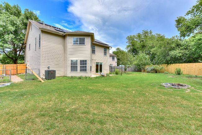 Side yard already has an established garden area with beds and there is already a built-in fire pit! | Image 34