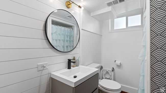 Bathroom featuring visible vents, curtained shower, vanity, and toilet | Image 18