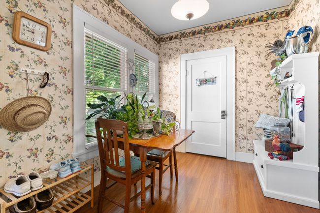 Dining space featuring wallpapered walls, light wood-style flooring, and baseboards | Image 16