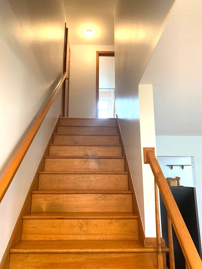 natural wood stairs headed upstairs | Image 23