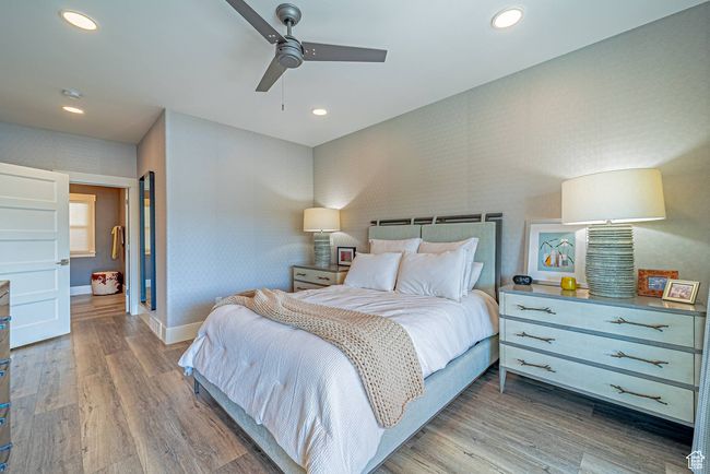 Bedroom with wood finished floors, baseboards, recessed lighting, and a ceiling fan | Image 6