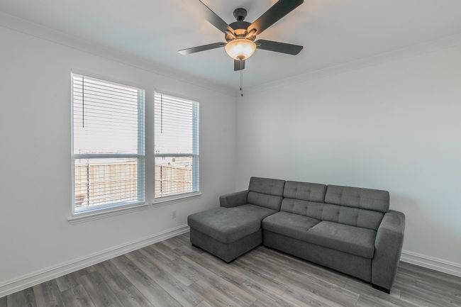 Living room with hardwood / wood-style floors, ceiling fan, and ornamental molding | Image 18